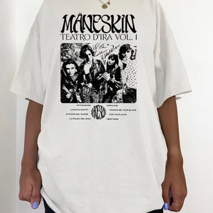 May include: White t-shirt with a black and white image of a band, "M&aring;neskin", with the text "Teatro d'Ira Vol. I" and a list of song titles.