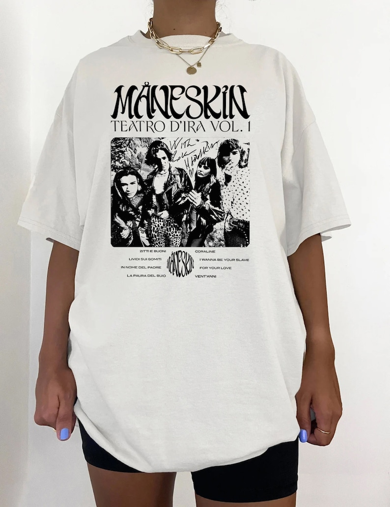 May include: White t-shirt with a black and white image of a band, "M&aring;neskin", with the text "Teatro d'Ira Vol. I" and a list of song titles.