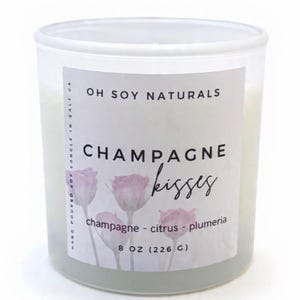 May include: A white ceramic mug with a black handle and the text "But First, Coffee" in a bold, black font. The mug is sitting on a wooden surface. The mug is approximately 4 inches tall.