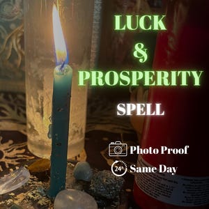 May include: A lit teal candle stands on a dark base surrounded by small polished stones and herbs. Text reads LUCK & PROSPERITY SPELL, Photo Proof, and 24h Same Day. A large red candle is visible to the right of the lit teal candle.