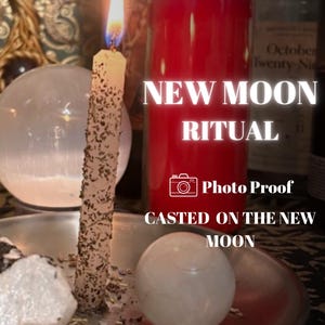 May include: A lit, herb-coated taper candle stands on a silver-toned plate next to a smooth, round, white stone. Behind it, a tall red pillar candle is visible. Text on the image reads: NEW MOON RITUAL, Photo Proof, CASTED ON THE NEW MOON.
