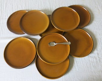 9 dessert plates plus a brown serving dish in very good condition.
