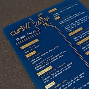 May include: A blue cheat sheet with gold text and a circuit board design. The text includes "curl:// Cheat Sheet", "Hide Progress", "Verbose", "Extra Info", and "Output", along with command options. The card is rectangular.