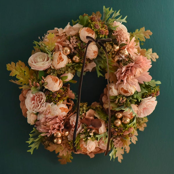 Golden wreath. A wreath of artificial flowers on the front door. Christmas wreath. Home decoration.