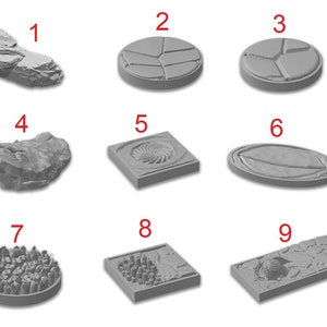 May include: Nine different gray resin miniature terrain pieces for tabletop gaming. The pieces include a variety of shapes and textures, such as rocks, craters, and cobblestone.