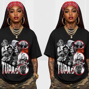 May include: A black short-sleeve t-shirt featuring a graphic collage of Tupac Shakur in black and white. The design includes circular frames, the text "TUPAC" in a bold white font, and "SHAKUR" in red script. The shirt has a crew neckline.
