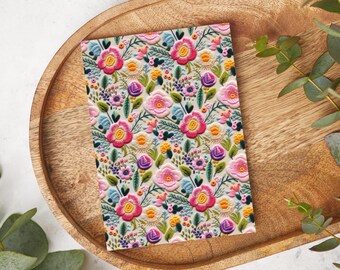 May include: A floral patterned card with pink, red, blue, green, and yellow flowers on a cream background.