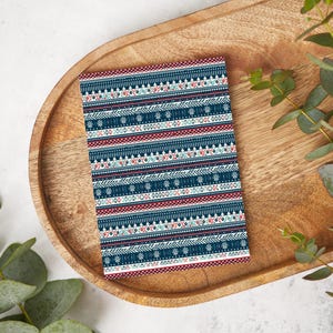 May include: A blue and red patterned card with a geometric design. The card is on a wooden tray.