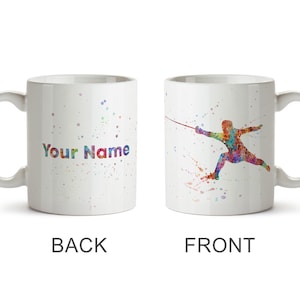 May include: White ceramic mug featuring a colorful watercolor design. The front displays a fencing figure in vibrant hues, while the back has the text "Your Name" in a rainbow font. The mug is a standard size with a curved handle.