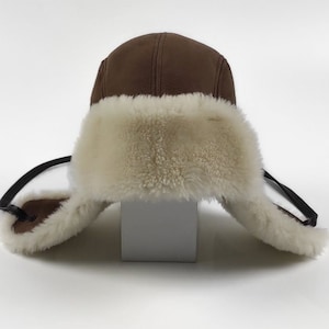 Brown suede Sheepskin aviator hat , trapper hat , lambskin mens hat . Hat with earflaps & white curly sheepskin wool