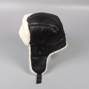 Sheepskin trapper hat in black & white . A napalan sheepskin hat with earflaps and holes .Great fit , gift idea for him