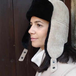 Sheepskin aviator hat for women. A combination of Corduroy fabric in beige & black sheepskin . A great winter hat for women .Great gift idea
