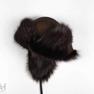 The ultimate trapper hat. Beaver hat with earflaps & leather strings.Dark brown long-haired beaver, dark brown sheepskin. Great gift for him
