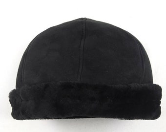 May include: A black fleece hat with a faux fur brim. The hat is made of a soft, warm material and is perfect for cold weather.