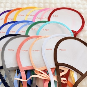 May include: A collection of seventeen handheld fans with white mesh centers and colored fabric borders. Each fan features a numbered label from 1 to 17, including colors like purple, orange, yellow, pink, red, blue, green, aqua, navy, grey, rose, peach, white, and brown.