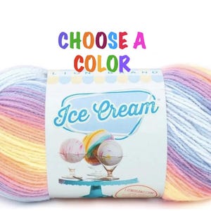May include: A skein of multi-colored yarn in shades of pink, yellow, and blue. The yarn is labeled "Ice Cream" and is available in a variety of colors.