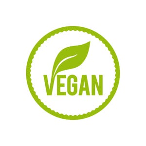 May include: A green and white vegan symbol. The word "VEGAN" is in green, bold letters, beneath a green leaf. The text is inside a white circle, which is surrounded by a green, scalloped border. The background is white.