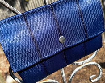 The Foldover Crossbody Clutch Seat Belt Bag in Navy Blue