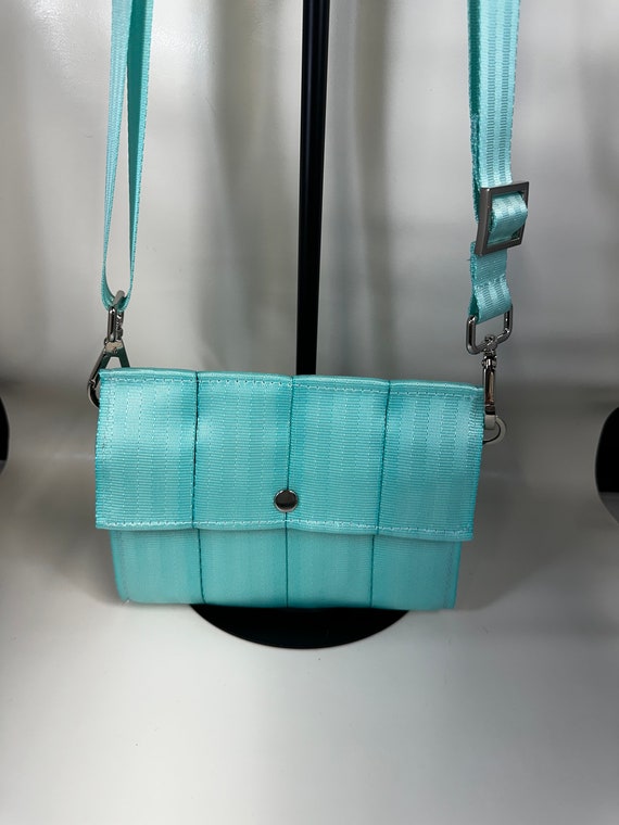 The Foldover Crossbody Clutch Seat Belt Bag in Minty Aqua