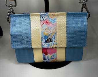 The Foldover Crossbody Clutch Seat Belt Bag in Powder Blue and Floral