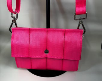 The Foldover Crossbody Clutch Seat Belt Bag in Fluorescent Pink