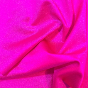 May include: A close-up of a bright pink fabric with a subtle shimmer. The fabric is wrinkled and has a soft, smooth texture.
