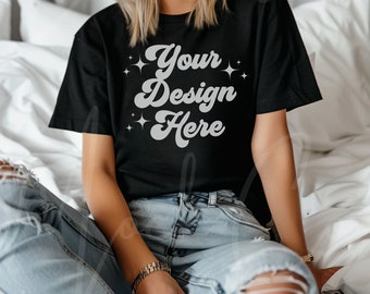 May include: A black t-shirt with the text "Your Design Here" in a retro font with silver glitter accents.