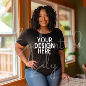 May include: A black t-shirt with the text "YOUR DESIGN HERE" printed in white on the front. The shirt is being worn by a person with dark hair and a smile.