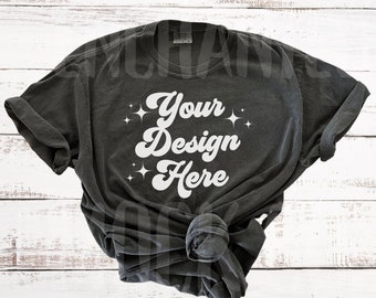 May include: A dark gray t-shirt with a white design that says "Your Design Here" with small white stars around the text.