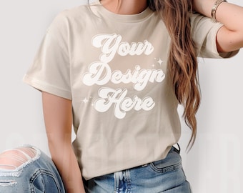 May include: A beige t-shirt with the text "Your Design Here" in a white retro font.