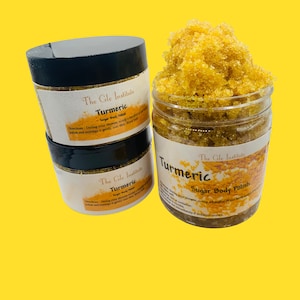 May include: Two glass jars of turmeric sugar body polish with black lids. The jars are labelled "The Gle Institute Turmeric Sugar Body Polish".