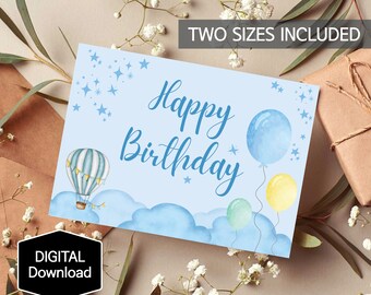 May include: A blue and white hot air balloon with a banner and stars floats above clouds with three blue, green, and yellow balloons. The text "Happy Birthday" is written in blue cursive script.