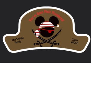 May include: A brown pirate hat-shaped graphic with a Mickey Mouse-inspired face, red and white striped bandana, and crossed swords. Text includes "You've Been Pixie Plundered!" and "The Smithe Family" and "Cabin: #1056".
