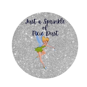 May include: A silver glitter background with the text "Just a Sprinkle of Pixie Dust" in navy blue lettering. A cartoon image of Tinkerbell, the fairy from Peter Pan, is flying with her wand in hand.