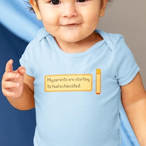 A smiling baby wearing a light blue bodysuit with a pixel art text box that says “My parents are starting to feel exhausted” with an empty energy bar next to the text box. A funny gamer baby outfit for tired parents and cozy farming sim game fans.