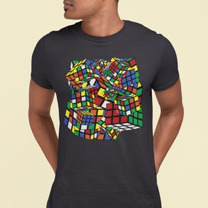 May include: A dark gray t-shirt with a colorful, abstract design of multiple Rubik's Cubes.