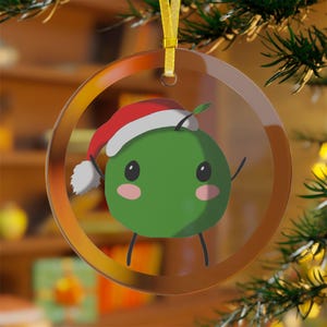 Glass Christmas ornament with cute green pixel creature in Santa hat - holiday game decor, cozy tree decoration, farming sim game gift
