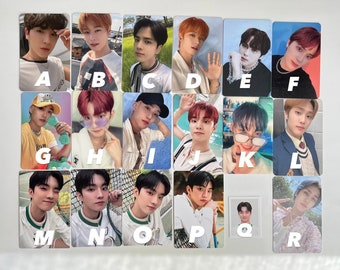 May include: A set of 18 photo cards featuring different members of a boy band. The cards are arranged in a grid with letters A through R labeling each card. The cards feature the band members in various poses and settings, including some with tennis rackets and others with a green background.