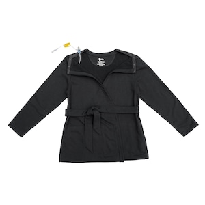May include: A black long-sleeved wrap-style top with a tie waist and snap closures along the shoulders. A medical tube with a yellow connector is visible near the neckline. The interior label displays text including the brand logo and size M.