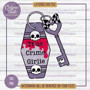 May include: A purple key tag with a red, white, and black skull and crossbones design. The tag says "True Crime Girlie".