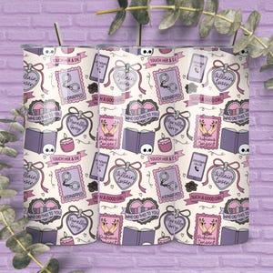 May include: A tumbler with a repeating pattern of pink and purple illustrations on a cream background. The design includes hearts, books, handcuffs, and phrases like "Villain Lover" and "Kidnapped." A silver straw is inserted in the top.
