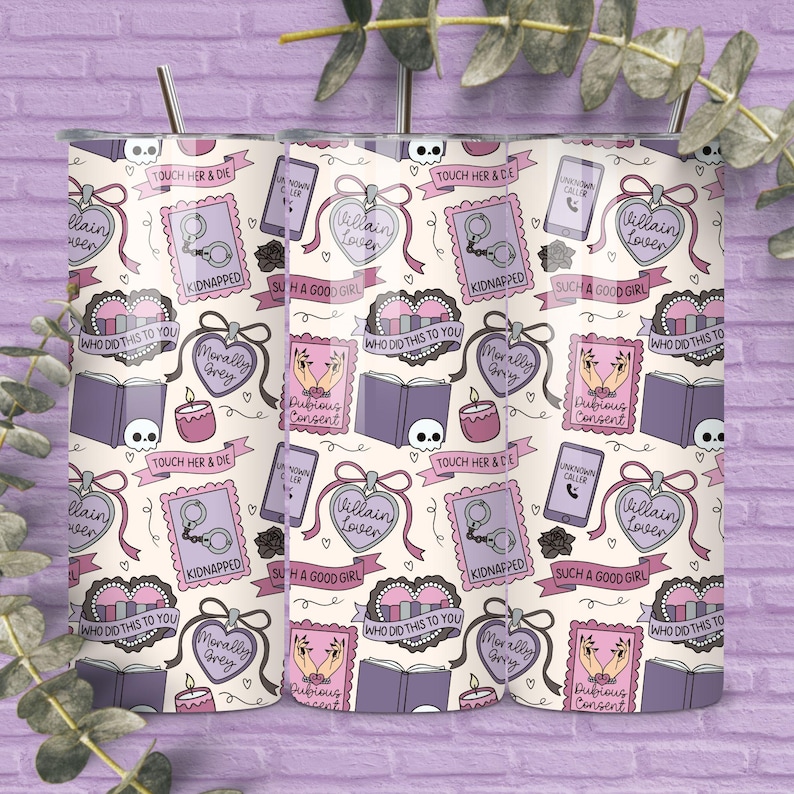 May include: A tumbler with a repeating pattern of pink and purple illustrations on a cream background. The design includes hearts, books, handcuffs, and phrases like "Villain Lover" and "Kidnapped." A silver straw is inserted in the top.