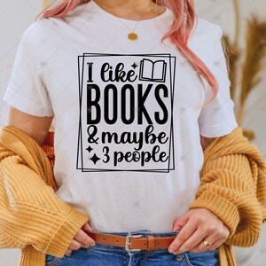 May include: White t-shirt with a black graphic that says "I like books & maybe 3 people".