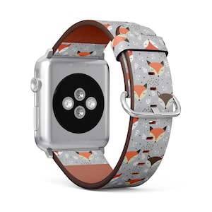 May include: A silver Apple Watch with a gray and orange fox print band. The band has a repeating pattern of foxes with orange fur and white accents.