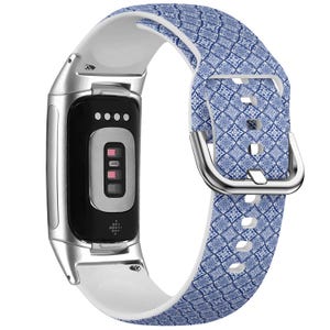 May include: A white and blue patterned silicone band for a fitness tracker. The band has a silver buckle and a white silicone strap.