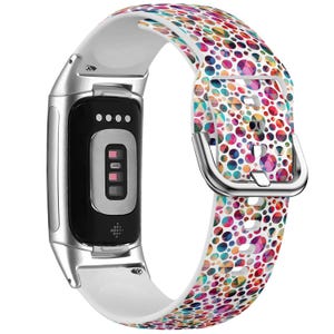 May include: A white and silver smartwatch band with a colorful geometric pattern. The band has a white background with a pattern of multi-colored circles and triangles.