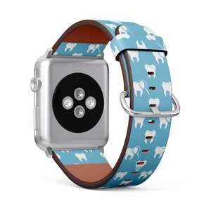May include: A light blue Apple Watch band with a white tooth and dental mirror pattern. The band is made of leather and has a brown leather lining.