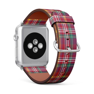 May include: A silver Apple Watch with a red, green and yellow tartan leather strap.