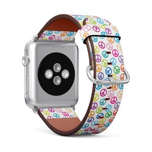May include: A white Apple Watch band with a colorful peace sign pattern. The band is made of leather and has a brown leather lining.
