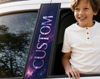 May include: A vertical car pillar decal featuring a deep space galaxy pattern in shades of purple, blue, and pink with the word CUSTOM printed in a bold, white, serif font running vertically along the length of the adhesive car trim piece.
